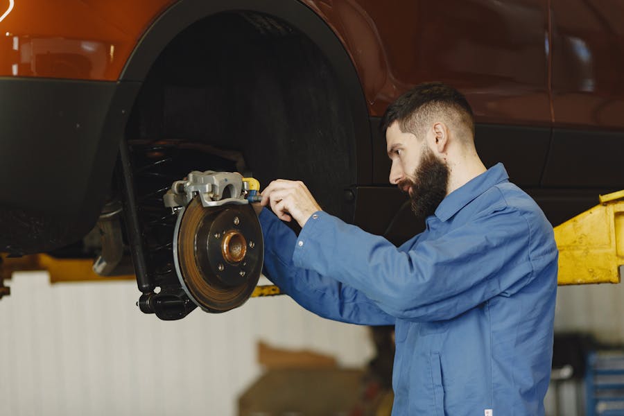 Mechanic inspecting brake system components at Kubin Automotive