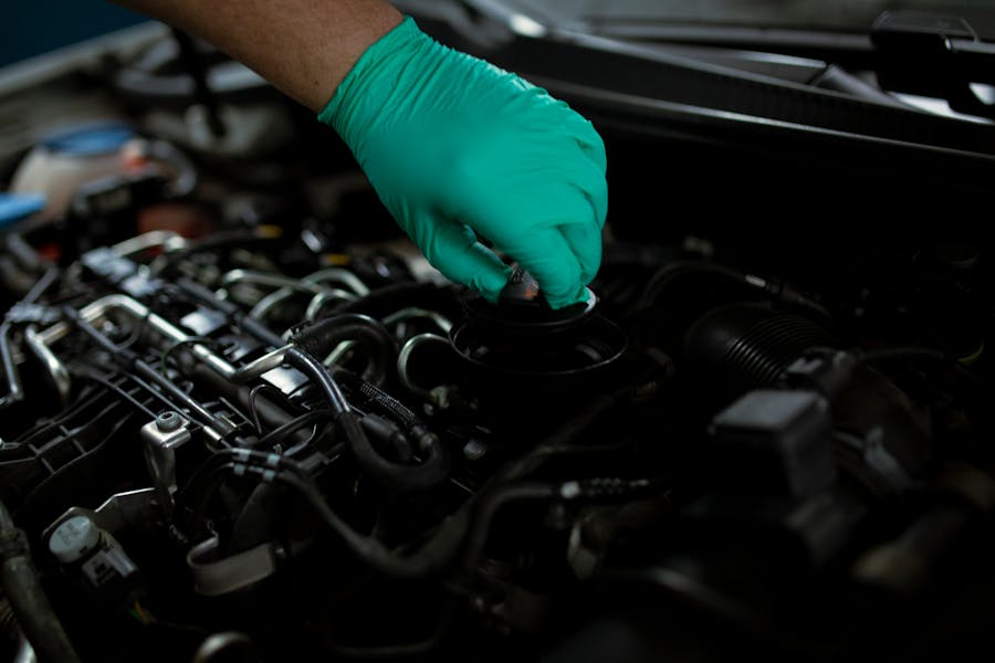 Mechanic performing preventive maintenance and engine inspection at Kubin Automotive